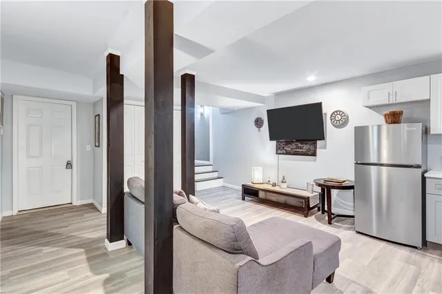 a bedroom with furniture and a flat screen tv