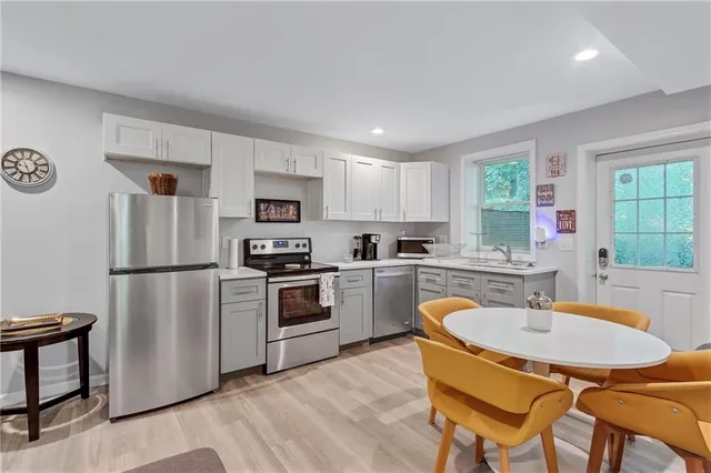 a kitchen with a refrigerator a stove a sink and a refrigerator