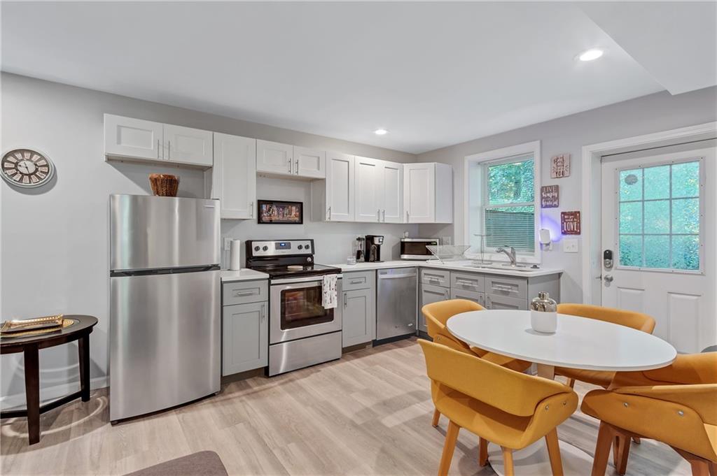 2418 Bolling Brook Drive Southwest Atlanta, GA 30311 - Photo 29 of 37 a kitchen with a refrigerator a stove a sink and a refrigerator