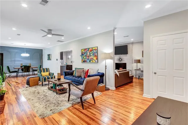 a living room with furniture and a wooden floor