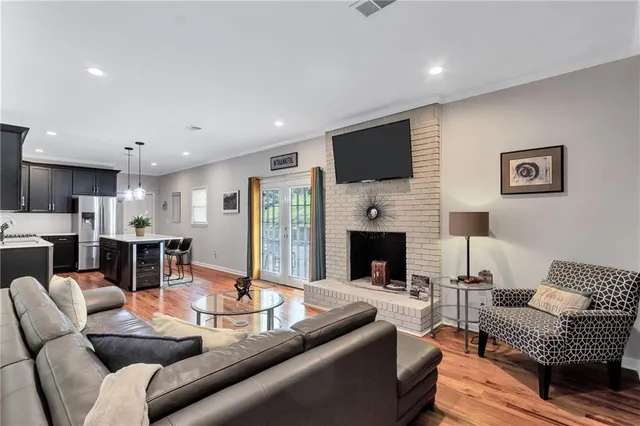 a living room with furniture fireplace and flat screen tv