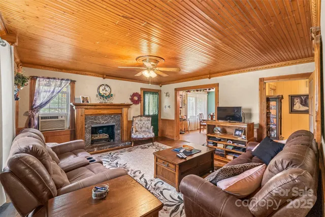 a living room with furniture a fireplace and a flat screen tv