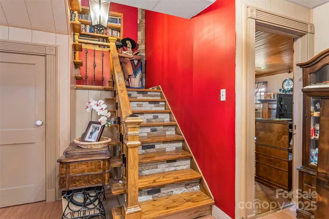 a view of an entryway with wooden floor and staircase