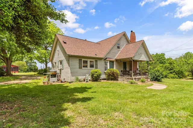 a front view of a house with yard and green space