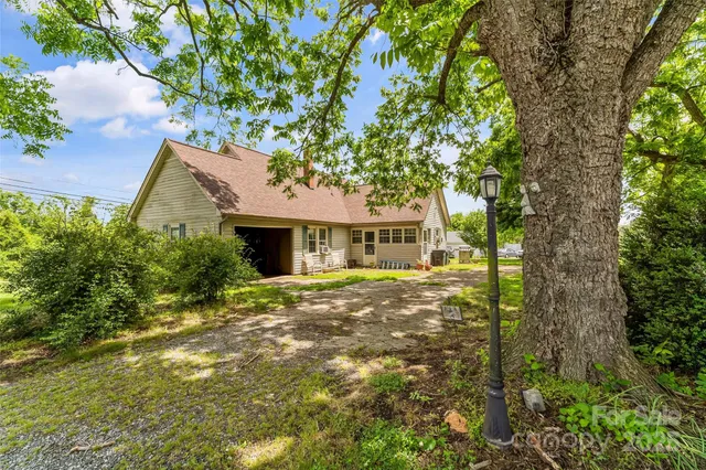 a view of a house with a tree in a yard