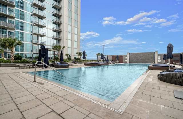 5925 Almeda Road, Unit 12308 Houston, TX 77004 - Photo 35 of 48 a view of swimming pool with outdoor seating and buildings in the background