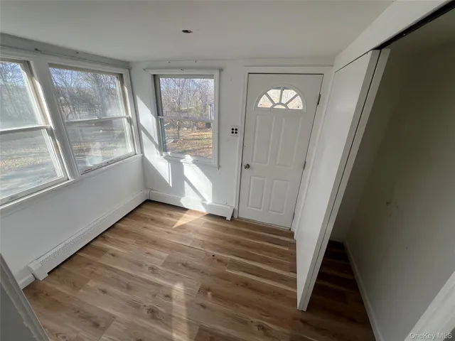 a view of an entryway with wooden floor