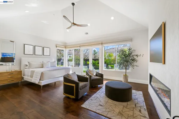 a spacious bedroom with a bed and a chandelier