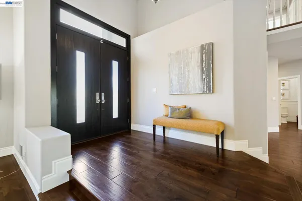 a kitchen with stainless steel appliances granite countertop a stove a sink dishwasher and cabinets with wooden floor