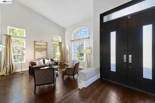 a living room with furniture a clock and a fireplace
