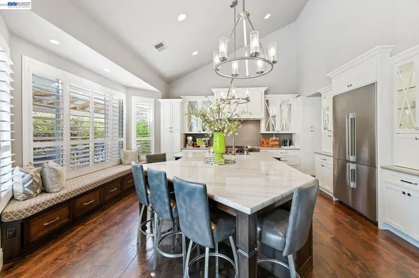 a kitchen with stainless steel appliances a stove and a large window