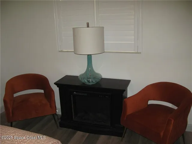 a living room with furniture and a lamp