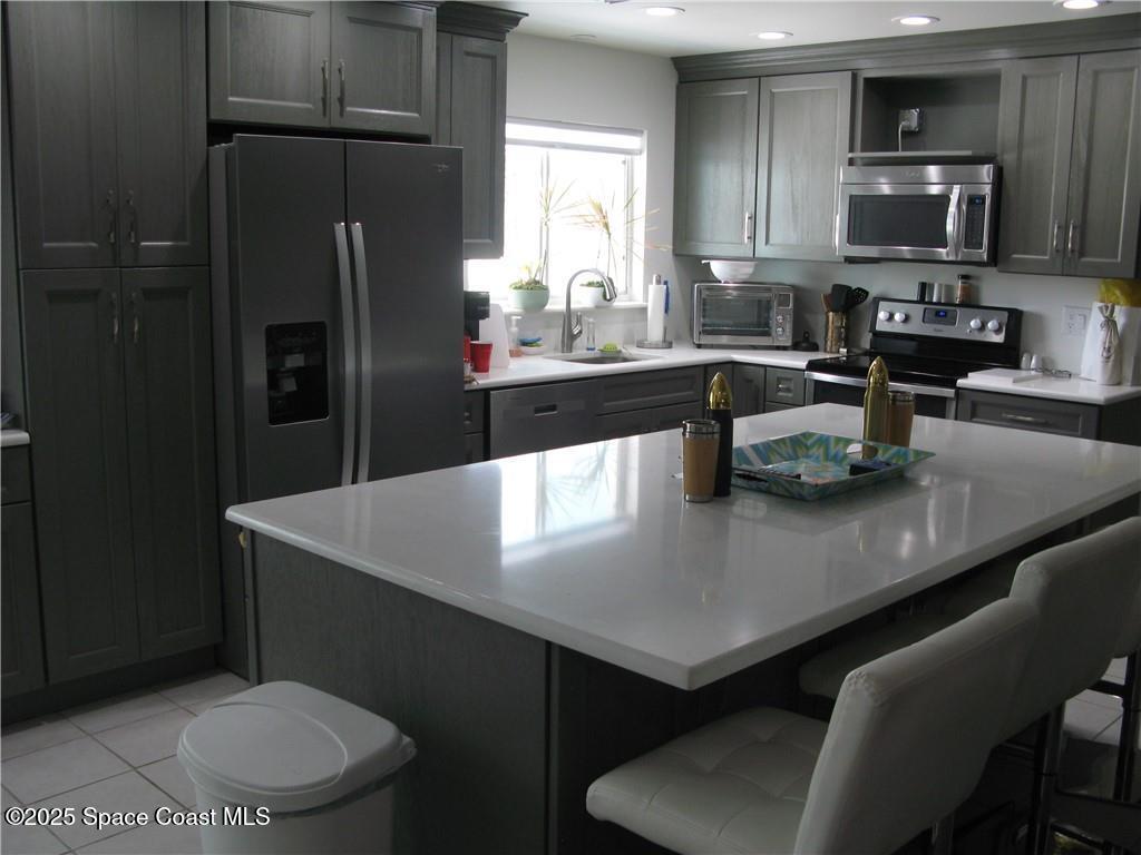 3700 Bay Street Sebastian, FL 32976 - Photo 2 of 34 a kitchen with stainless steel appliances a sink a table and chairs