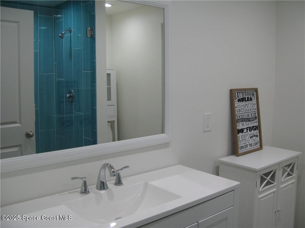 3700 Bay Street Sebastian, FL 32976 - Photo 22 of 34 a bathroom with a sink and a mirror