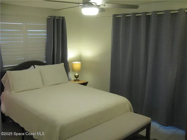 a bed sitting in a bedroom next to a bathroom