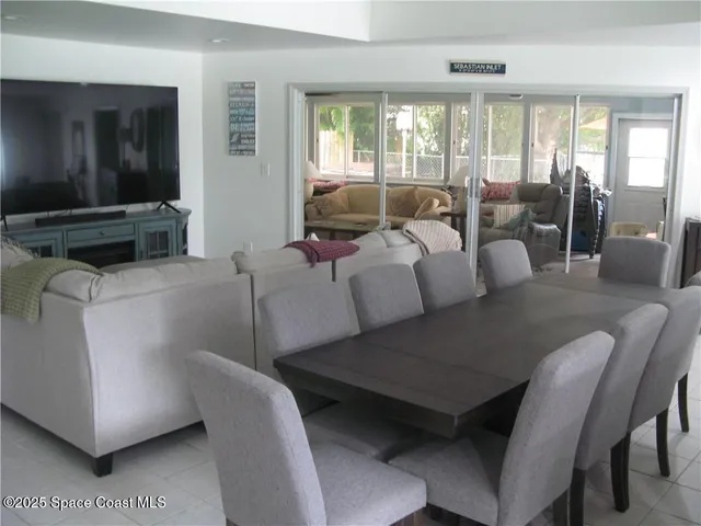 a living room with furniture and large windows