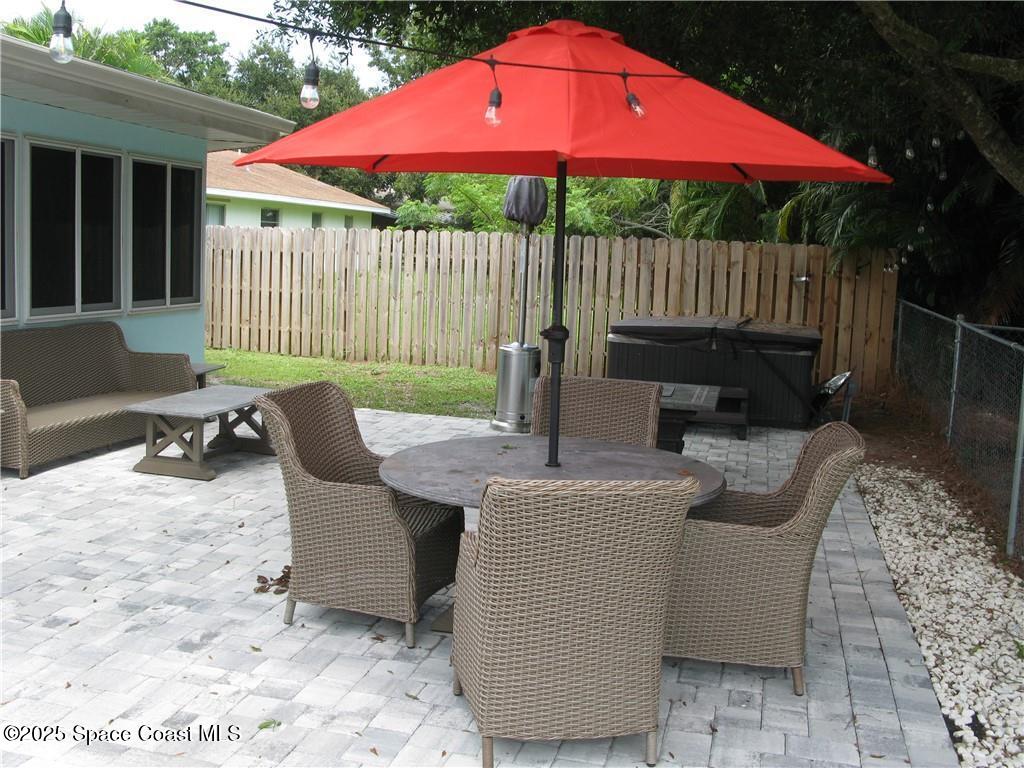 3700 Bay Street Sebastian, FL 32976 - Photo 31 of 34 a view of a patio with a table and chairs under an umbrella