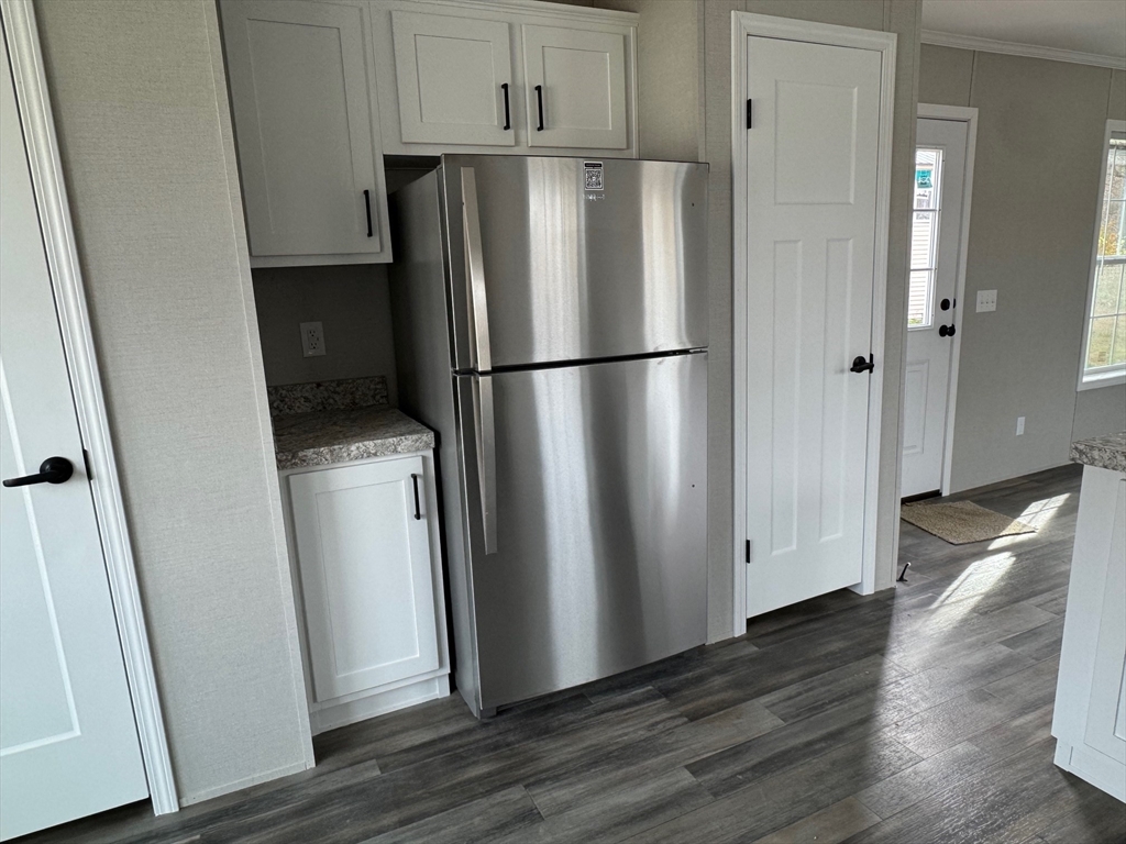 602 Fitchburg Road, Unit 19 Greenville, NH 03048 - Photo 6 of 14 a view of kitchen with wooden floor and electronic appliances