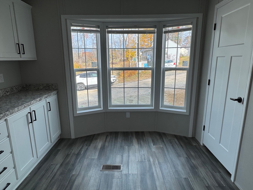 602 Fitchburg Road, Unit 19 Greenville, NH 03048 - Photo 7 of 14 wooden floor in an empty room with a window