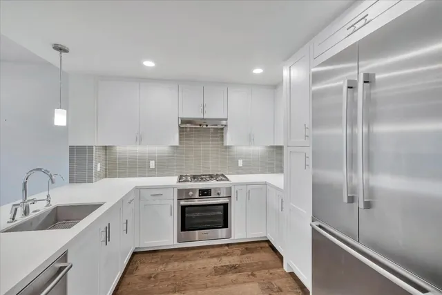a kitchen with a sink stainless steel appliances and cabinets