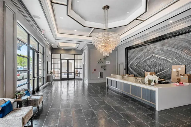 a living room with fireplace furniture and a large window