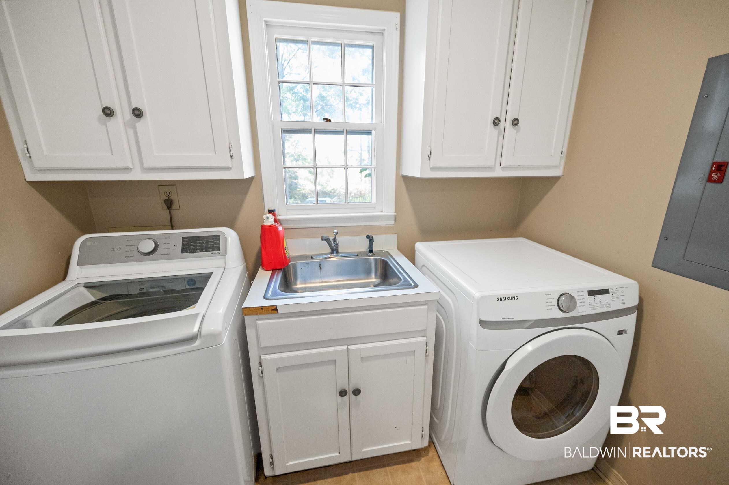6705 Ridgeland Road South Mobile, AL 36695 - Photo 34 of 44 Laundry area with washing machine and dryer, electric panel, cabinets, and sink