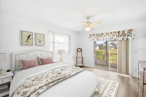 a bedroom with a large bed and a chandelier