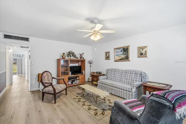 a living room with furniture a couch and a chandelier