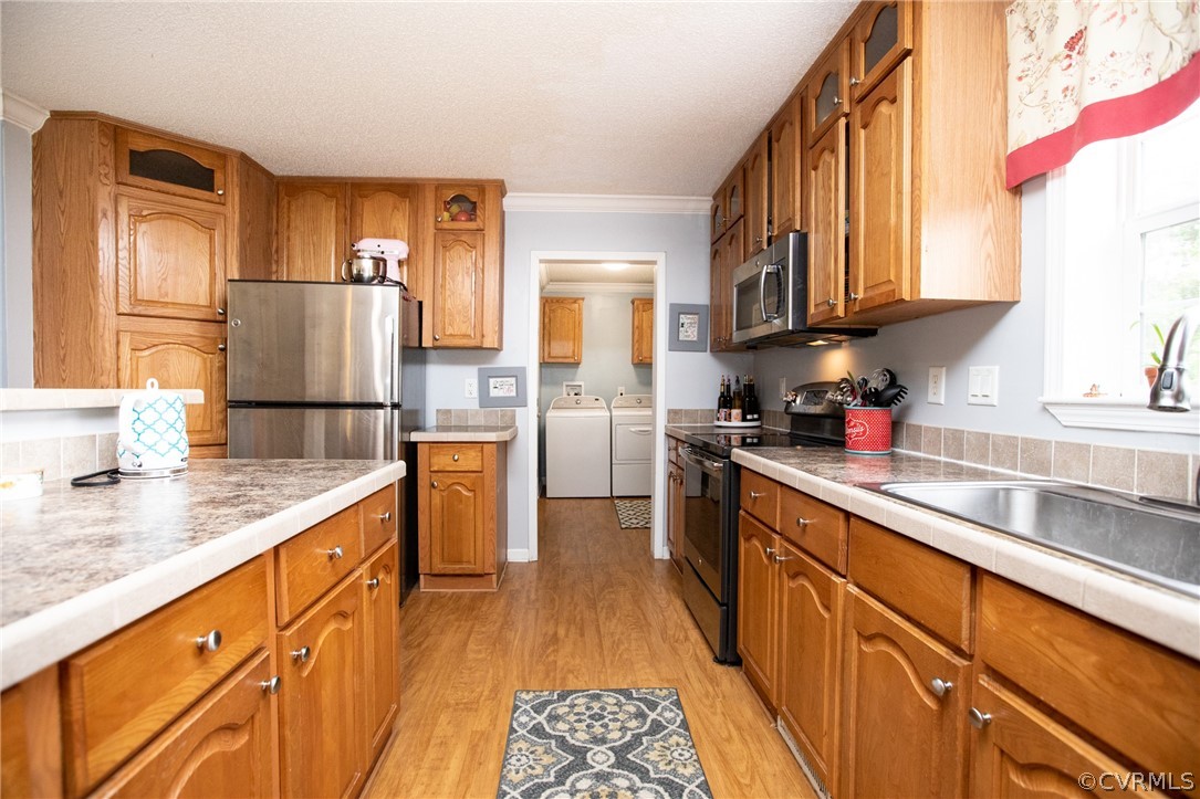 2862 Stage Coach Road Farmville, VA 23901 - Photo 16 of 48 a kitchen with stainless steel appliances granite countertop a refrigerator a sink dishwasher a stove with wooden floor and cabinets next to a window