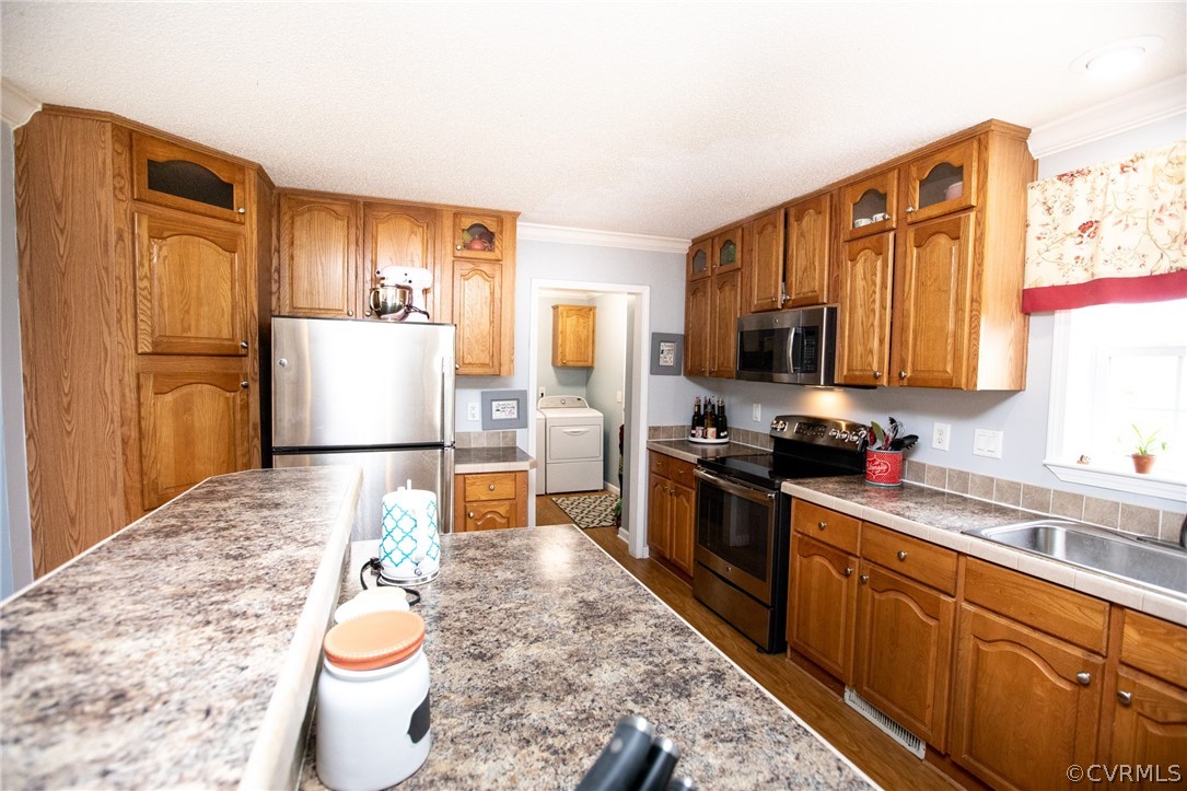 2862 Stage Coach Road Farmville, VA 23901 - Photo 21 of 48 a kitchen with a refrigerator sink and wooden cabinets