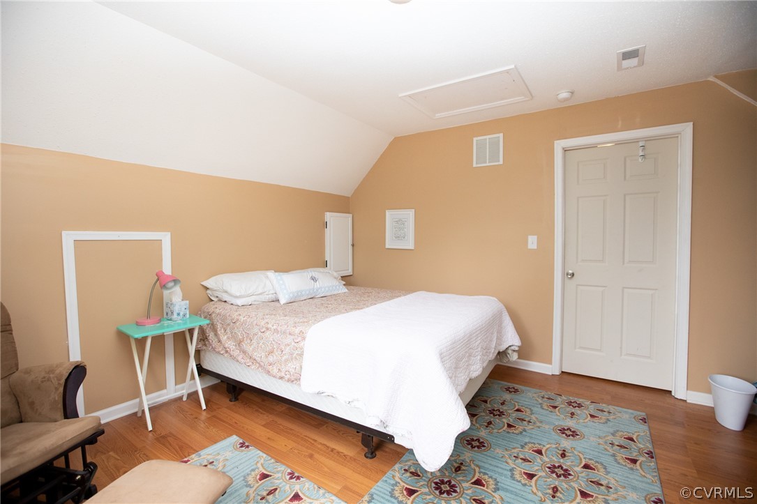 2862 Stage Coach Road Farmville, VA 23901 - Photo 39 of 48 a bedroom with a bed and wooden floor