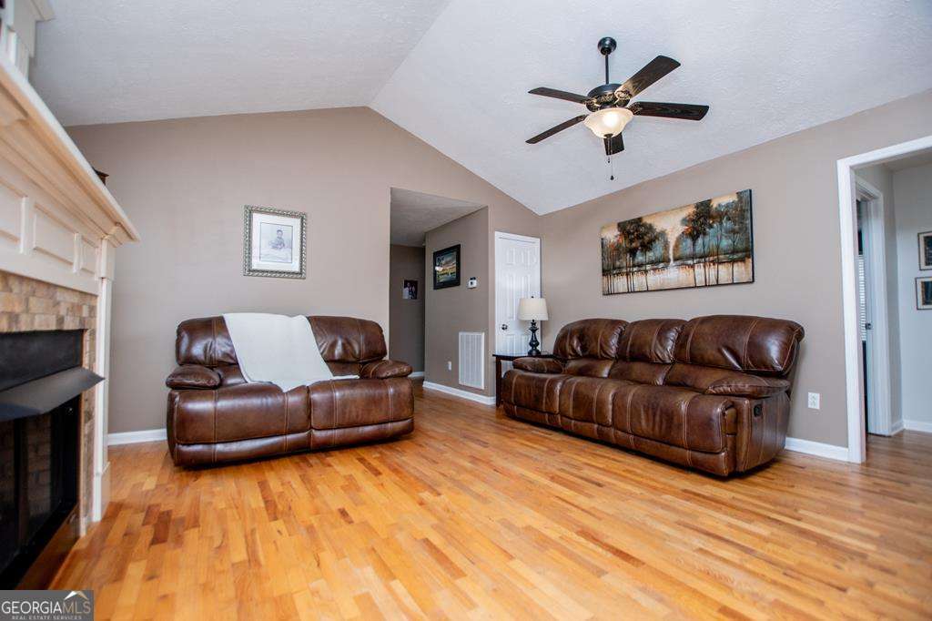 2 Pine Hill Drive Ranburne, AL 36273 - Photo 21 of 91 a living room with couches and a flat screen tv with kitchen view