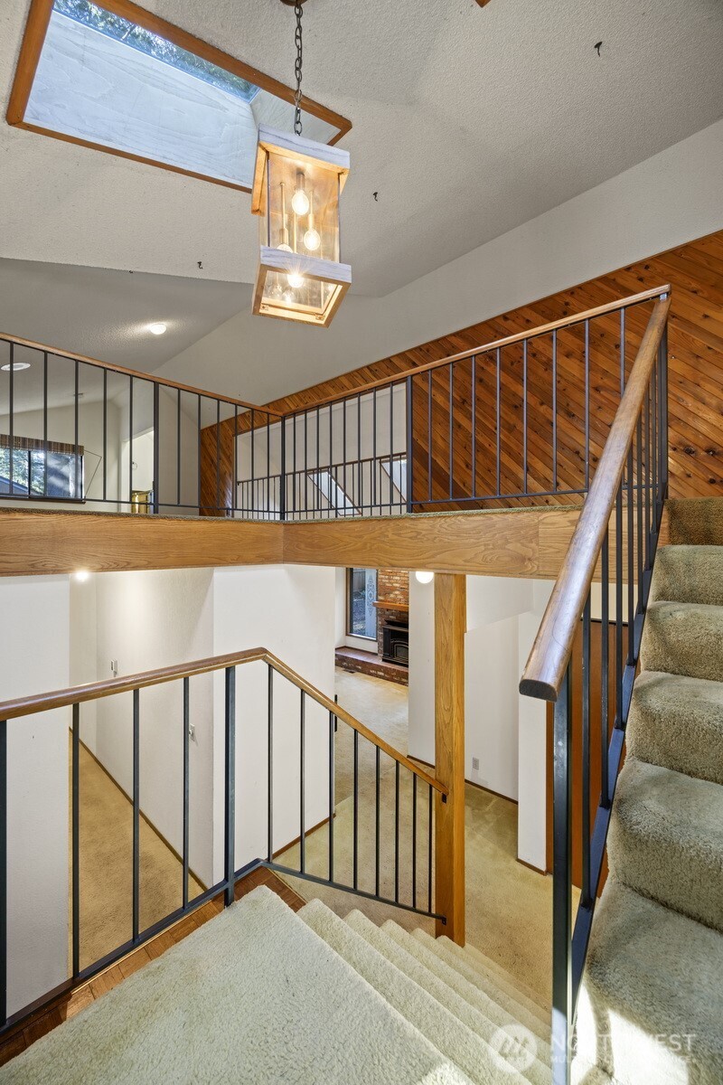 413 Viewcrest Road Bellingham, WA 98229 - Photo 22 of 40 a view of staircase with lots of frames on wall