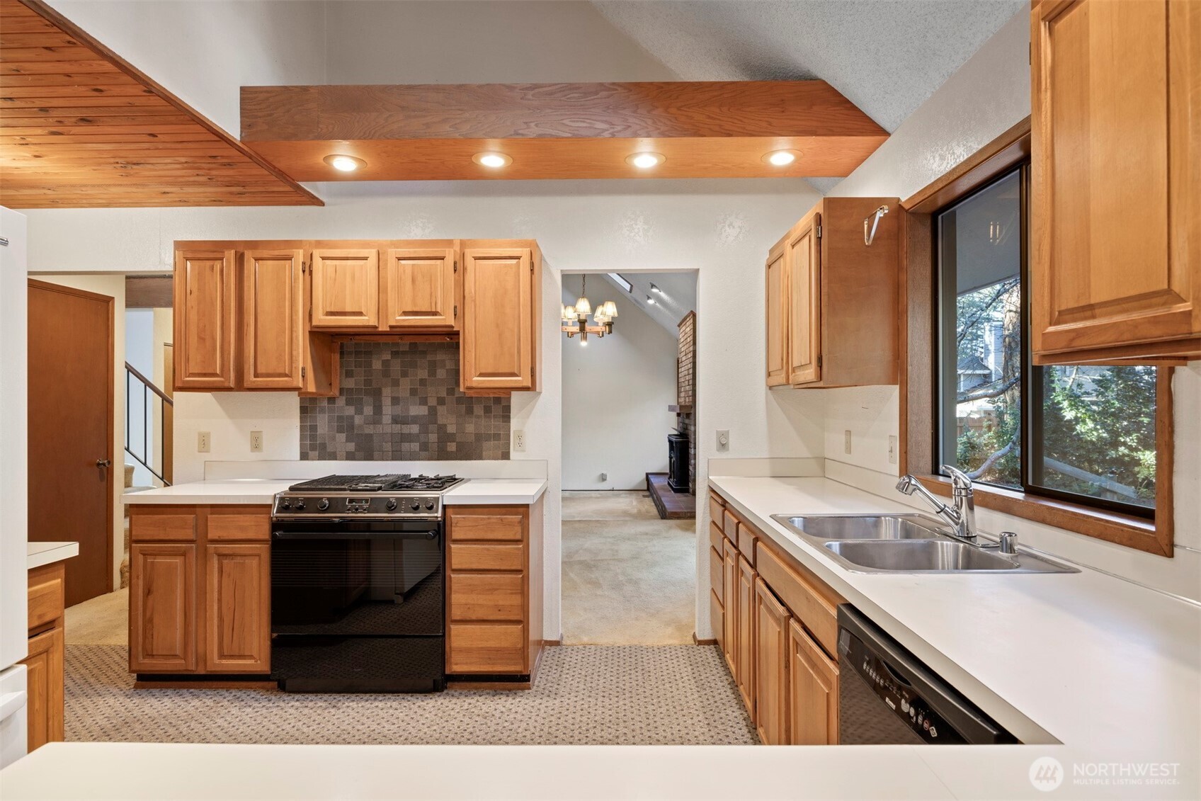 413 Viewcrest Road Bellingham, WA 98229 - Photo 10 of 40 a kitchen with stainless steel appliances granite countertop a sink stove and cabinets