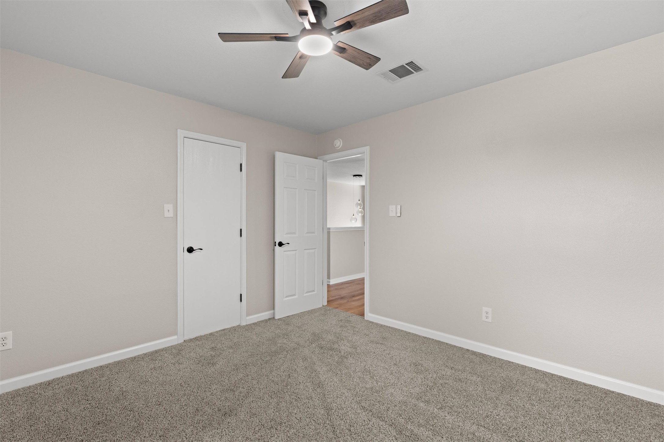 724 Lavaca Loop Elgin, TX 78621 - Photo 28 of 40 Plush carpeting and neutrally toned walls anchor this versatile bedroom space.