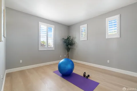 a view of a room with window and potted plant