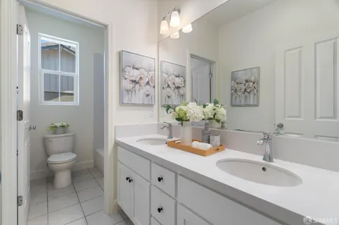 a bathroom with a toilet a sink and mirror