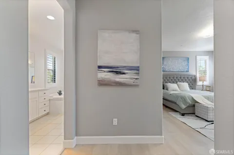 a bedroom with a large bed and windows