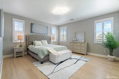 a bedroom with a large bed and a window