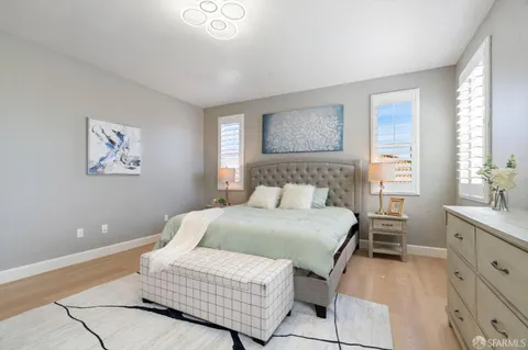 a bathroom with a granite countertop sink mirror and window