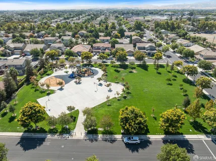 an aerial view of a residential houses with outdoor space
