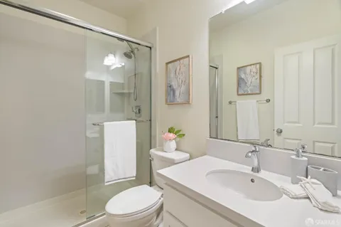 a bathroom with a sink toilet and shower