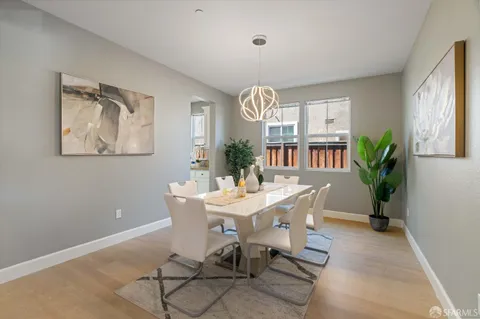 a view of a dining room with furniture and a potted plant
