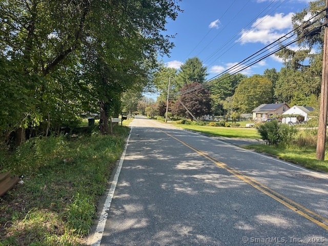 87 Fort Shantok Road Montville, CT 06382 - Photo 3 of 7 a view of a yard with plants and large trees