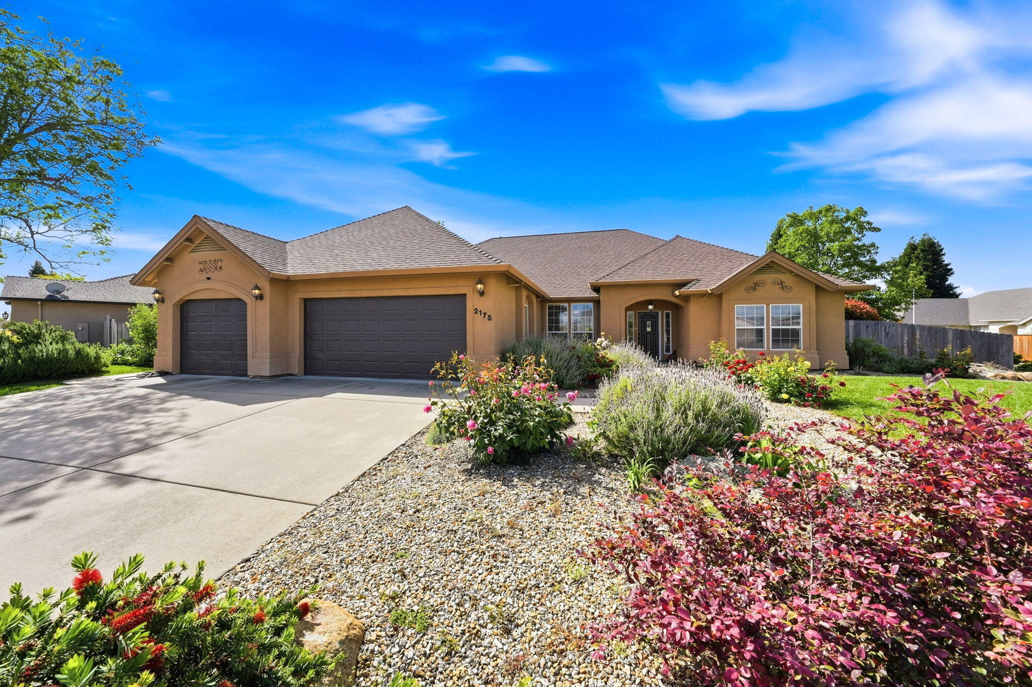 2175 Tradition Way Redding, CA 96001 - Photo 1 of 36 a front view of a house with a garden