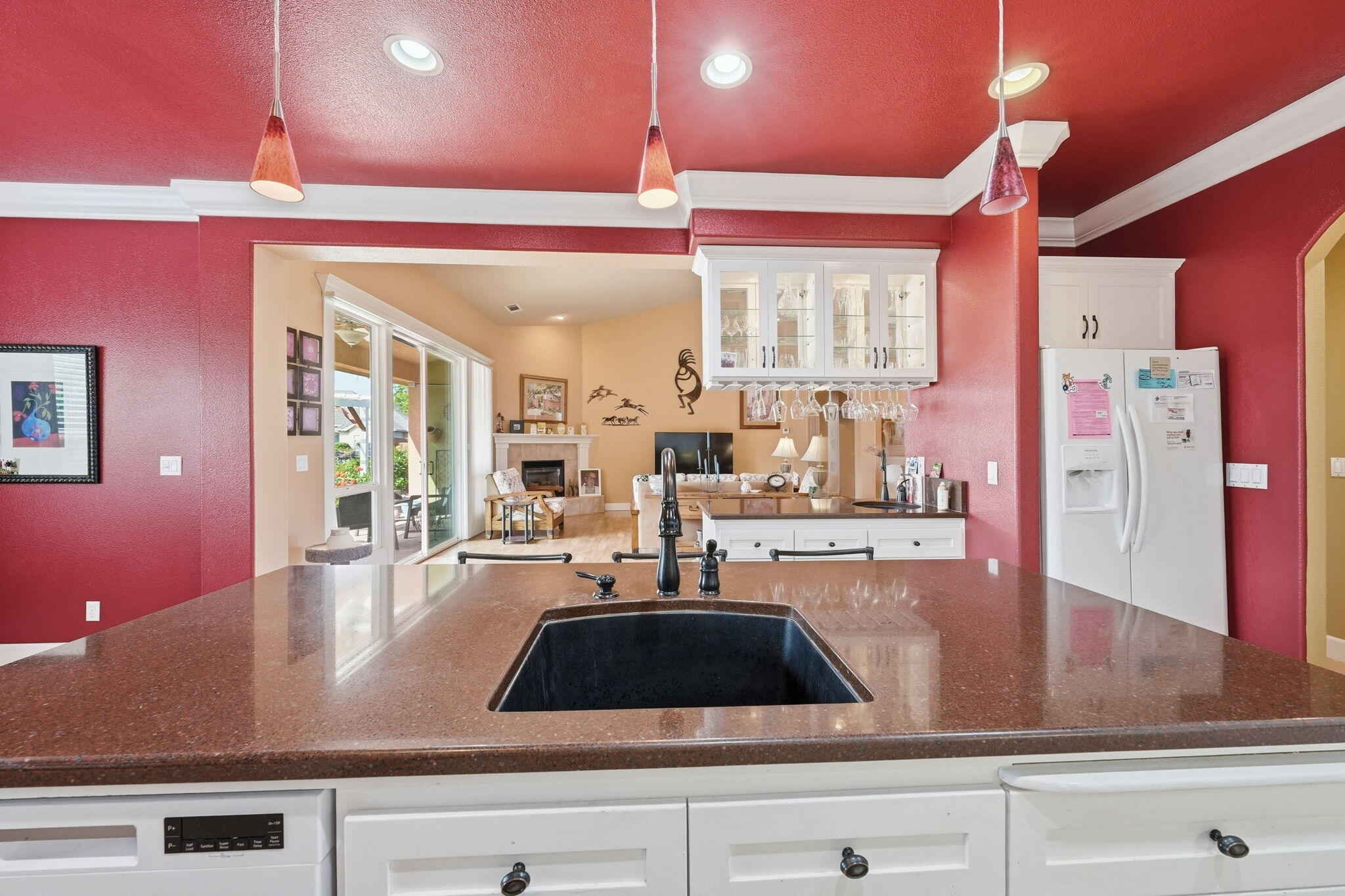 2175 Tradition Way Redding, CA 96001 - Photo 10 of 36 a kitchen with kitchen island granite countertop a sink and dishwasher with wooden floor