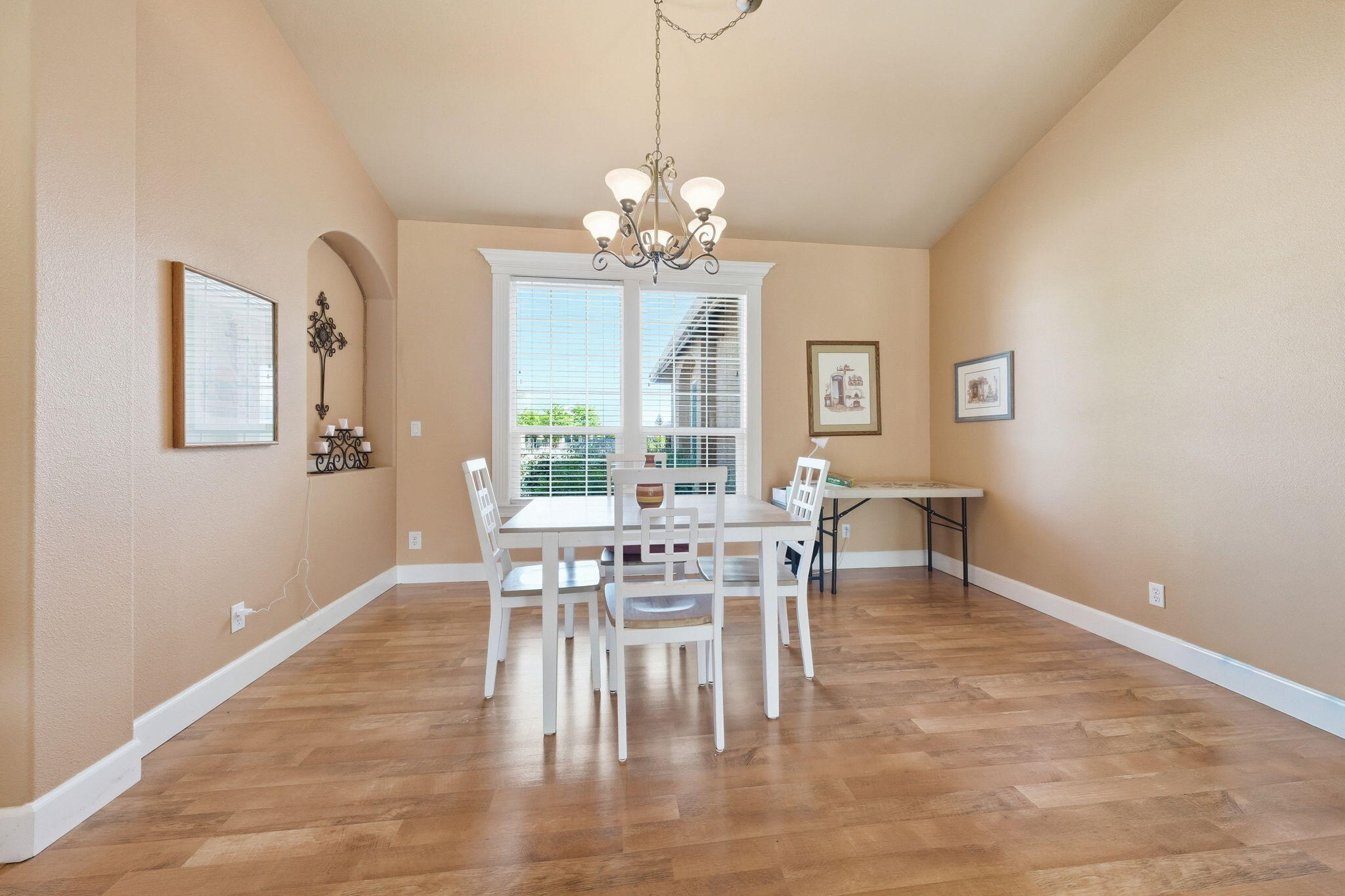 2175 Tradition Way Redding, CA 96001 - Photo 14 of 36 a dining room with wooden floor a chandelier a wooden table and chairs
