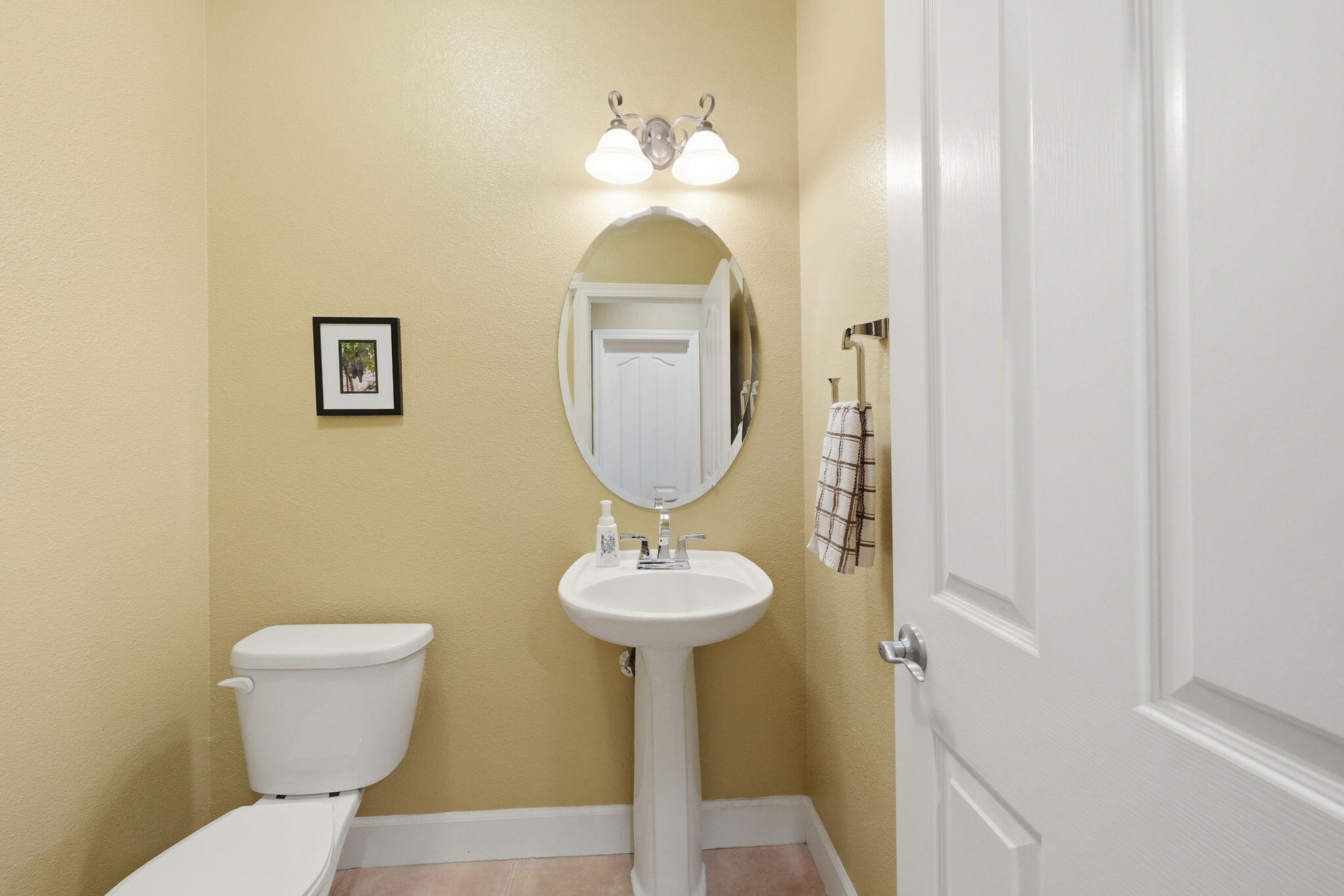 2175 Tradition Way Redding, CA 96001 - Photo 27 of 36 a bathroom with a toilet sink and mirror