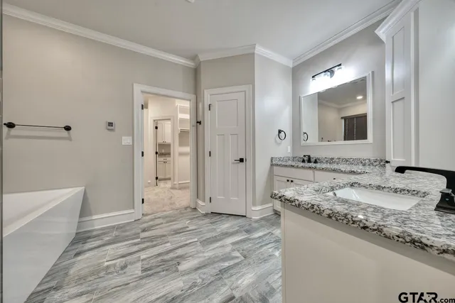 a bathroom with a granite countertop sink mirror and double