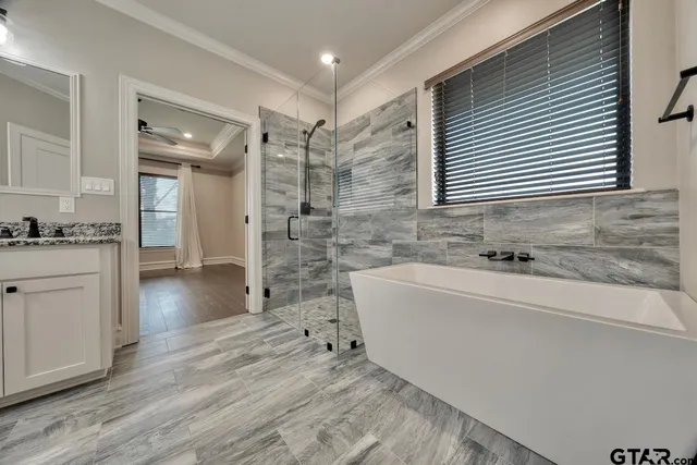 a spacious bathroom with a sink and a mirror